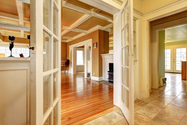 A pair of doors open to show off a beautifully renovated living room.